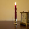 Old clock and candle minutes before New Year,