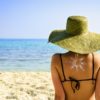 Woman on beach with sun symbol on her back