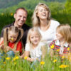 Happy family in summer on meadow